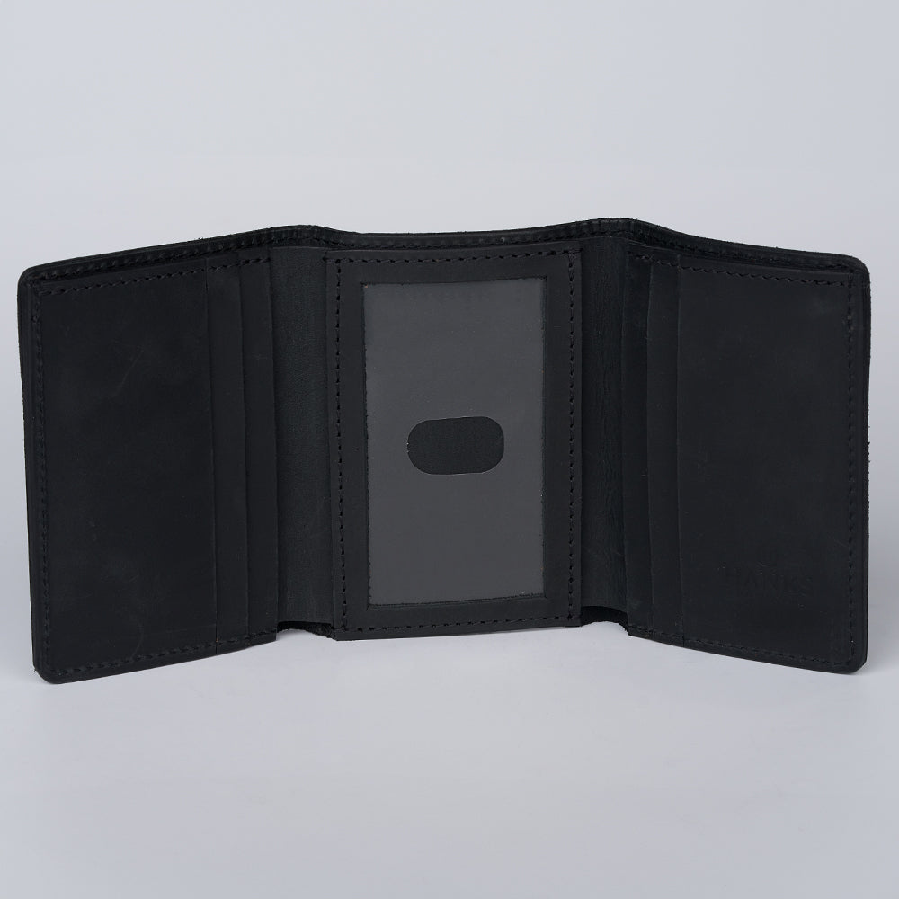 The Saranac Premium Trifold by Hanks Belts is shown open, displaying multiple card slots and a clear ID window. This American-made leather wallet rests against a plain light gray background.