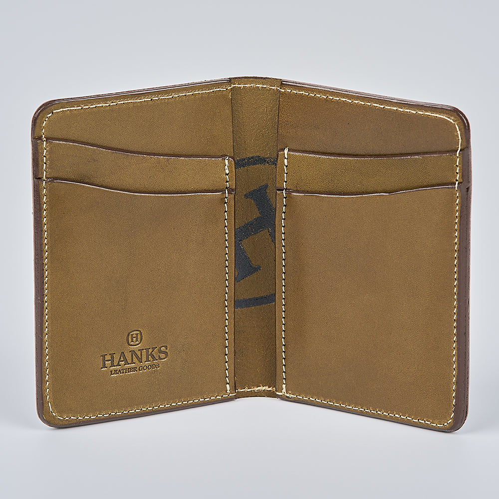 The Superior Front Pocket Bifold by Hanks Belts is a brown English Bridle Leather wallet with four card slots, an embossed "Hanks Leather Goods" logo inside, visible edge stitching, and is proudly made in the USA.