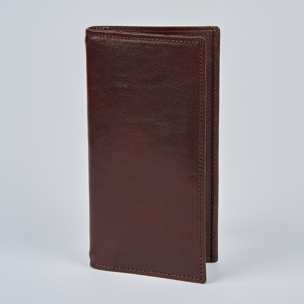 The Hanks Belts Vico Italian Breast Pocket Bifold is a closed, upright dark brown leather wallet with visible stitching, shown on a plain light grey background.