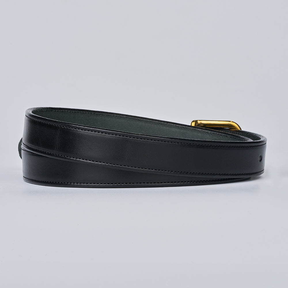 The Addyson - 1&quot; by Hanks Belts, a classic belt made from English Bridle Full-Grain Leather with a brass buckle, is coiled on a light gray background. It features a smooth finish and looks new and unused.