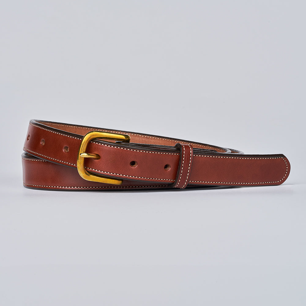 The Addyson by Hanks Belts is a classic brown English Bridle full-grain leather belt with white stitching and a gold-toned brass buckle, coiled neatly on a plain light gray background.