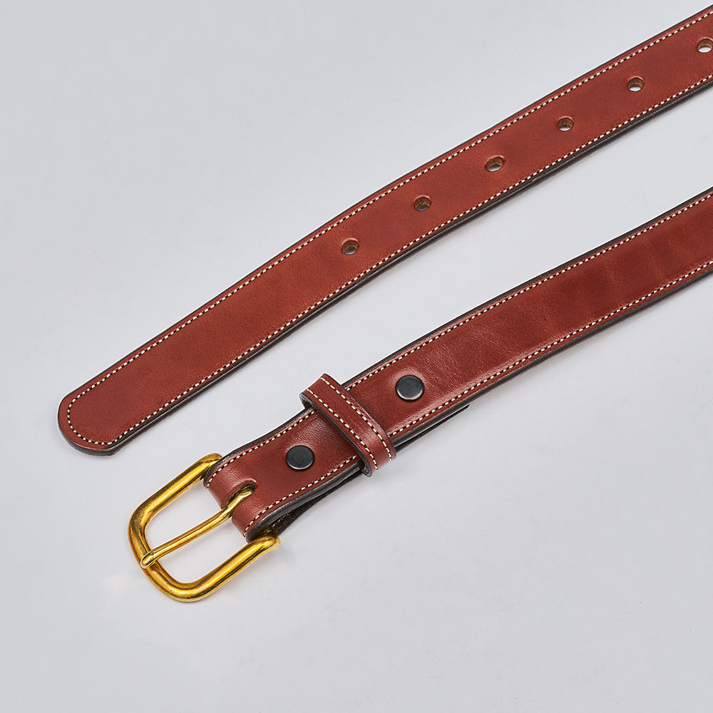 The Addyson by Hanks Belts is a classic belt made from English Bridle Full-Grain Leather with white stitching, a brass buckle, and multiple holes, shown on a light gray background.