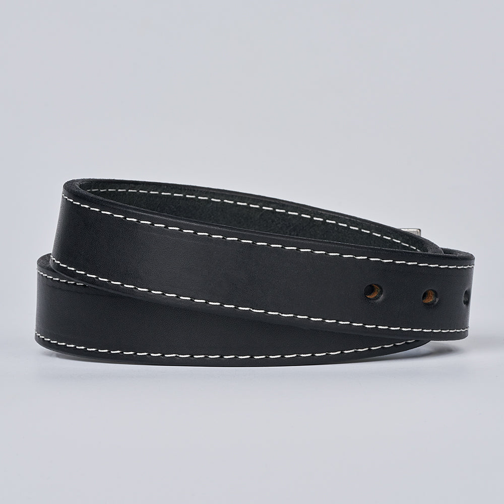 The Bonnie by Hanks Belts is a black full-grain leather belt featuring white edge stitching, shown coiled on a plain light gray background.
