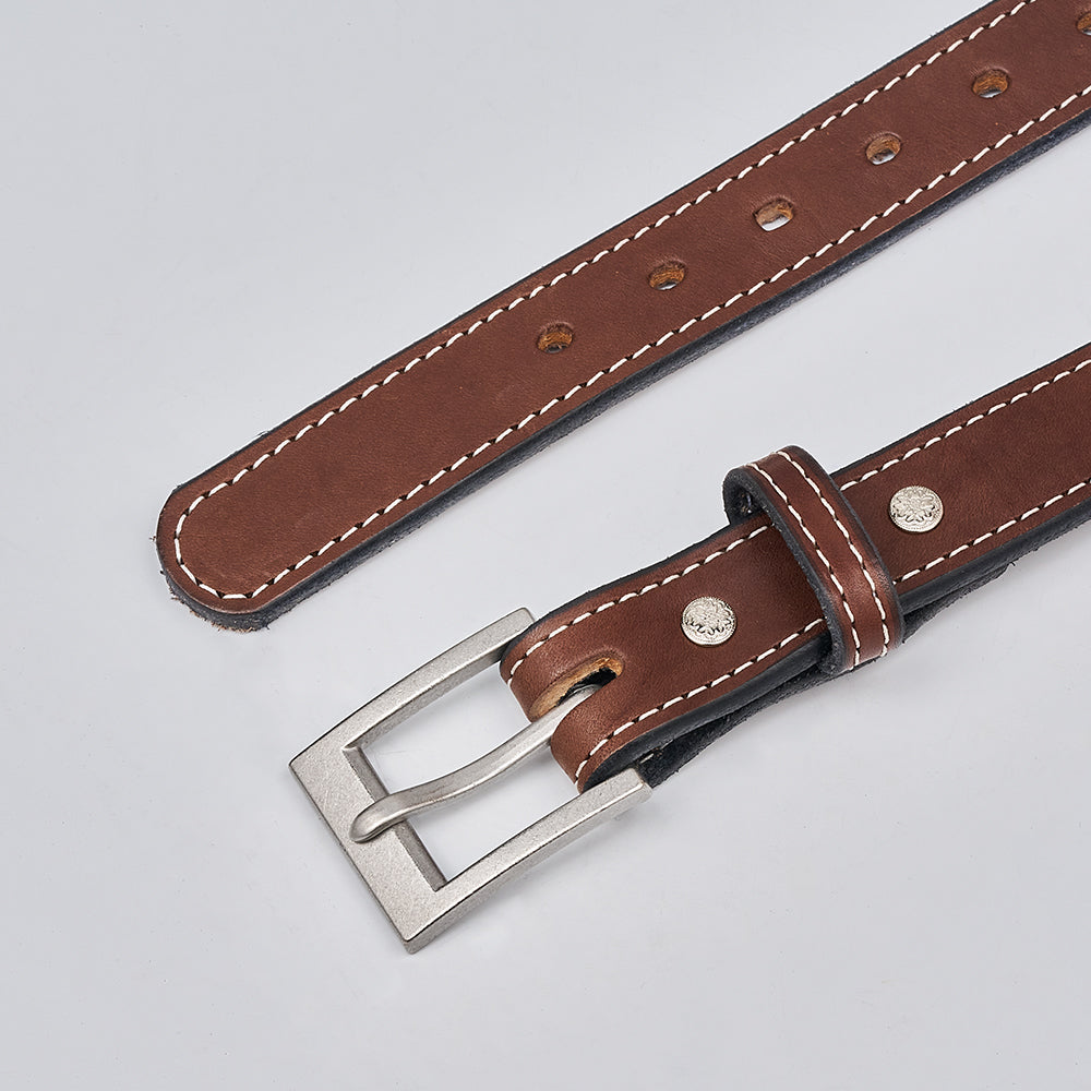 The Bonnie by Hanks Belts is a women’s full-grain leather belt with white stitching, silver rectangular buckle, and metal rivets, shown against a light grey background.