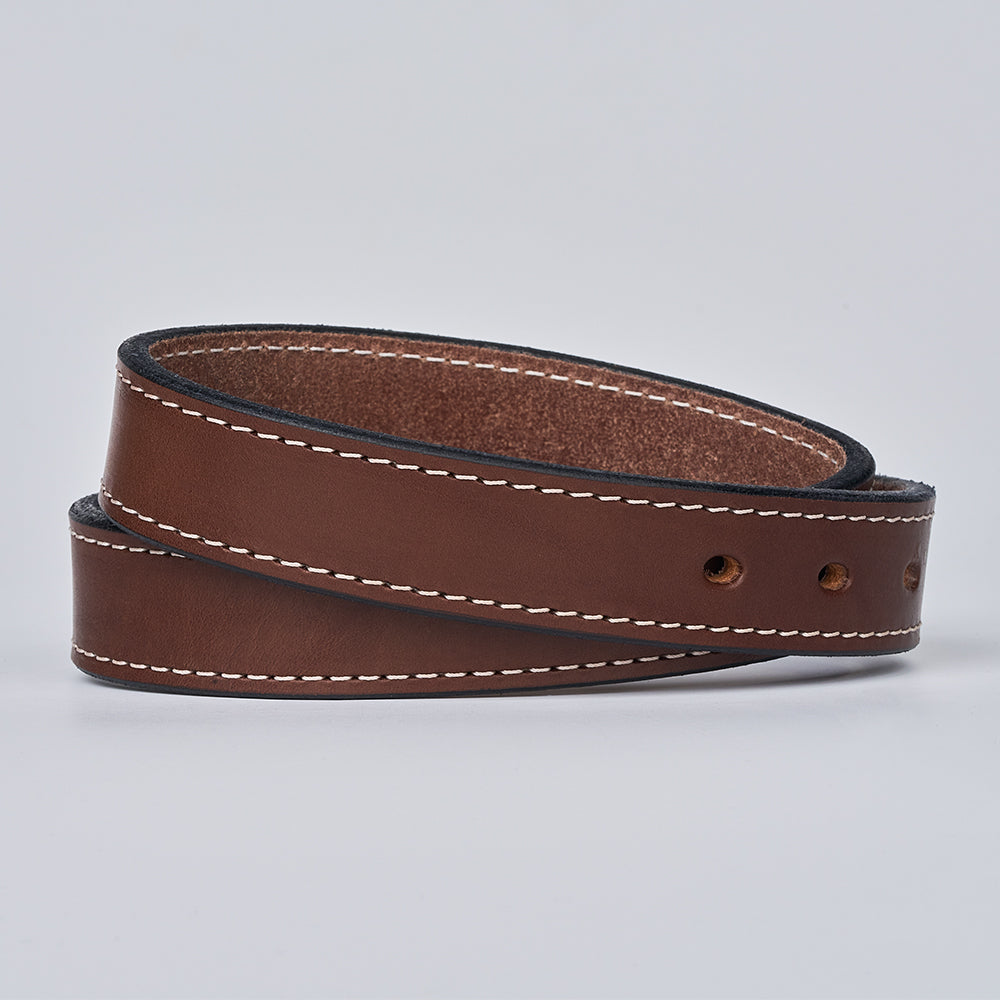 The Bonnie by Hanks Belts is a brown full-grain leather belt with white edge stitching and three visible holes, coiled and displayed on a plain light background.