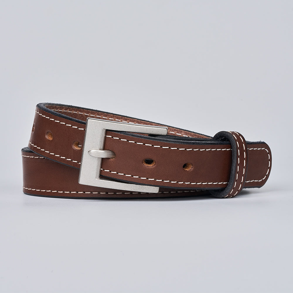 The Bonnie by Hanks Belts is a brown full-grain leather belt with white stitching, a silver rectangular buckle, and multiple holes, shown coiled neatly on a plain light gray background.