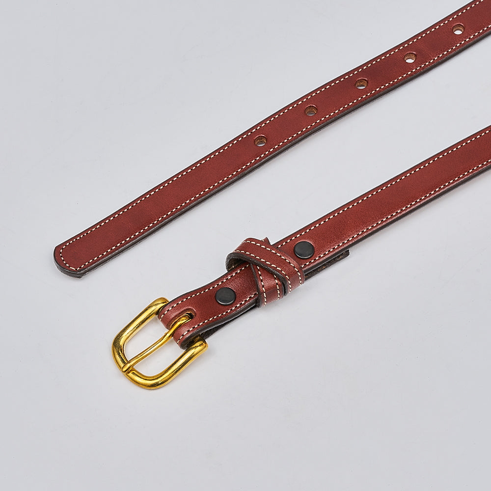 The Dixie by Hanks Belts is a stylish women&#39;s belt made from brown English Bridle leather with white stitching, multiple holes, and a gold-colored buckle, shown on a light gray background.