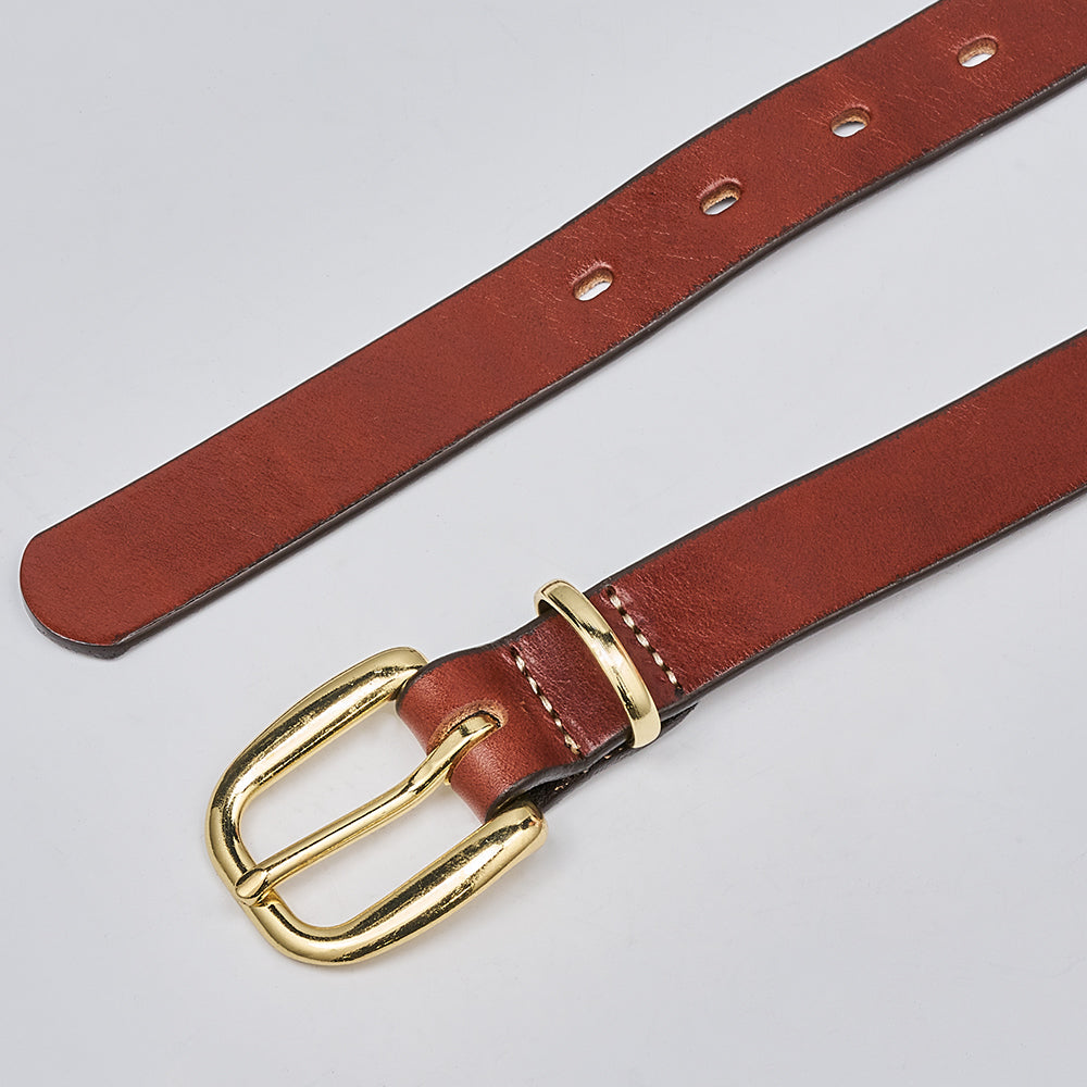 The Poppy by Hanks Belts is a women&#39;s oak leather belt with a shiny gold brass buckle, shown against a light gray background. It features multiple holes for an adjustable fit.