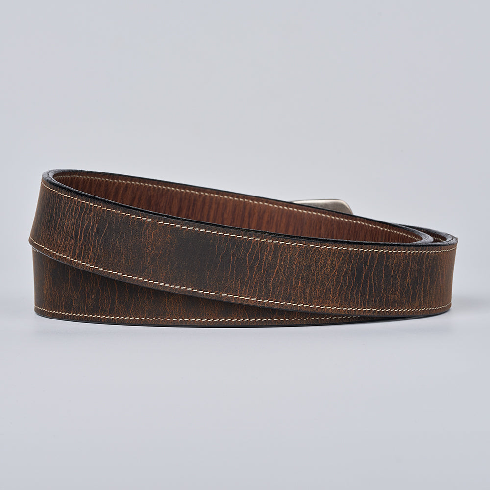 The Willow Bison by Hanks Belts is a durable leather women&#39;s western belt featuring textured grain and white stitching, shown coiled on a light gray background—perfect for adding timeless flair to any outfit.