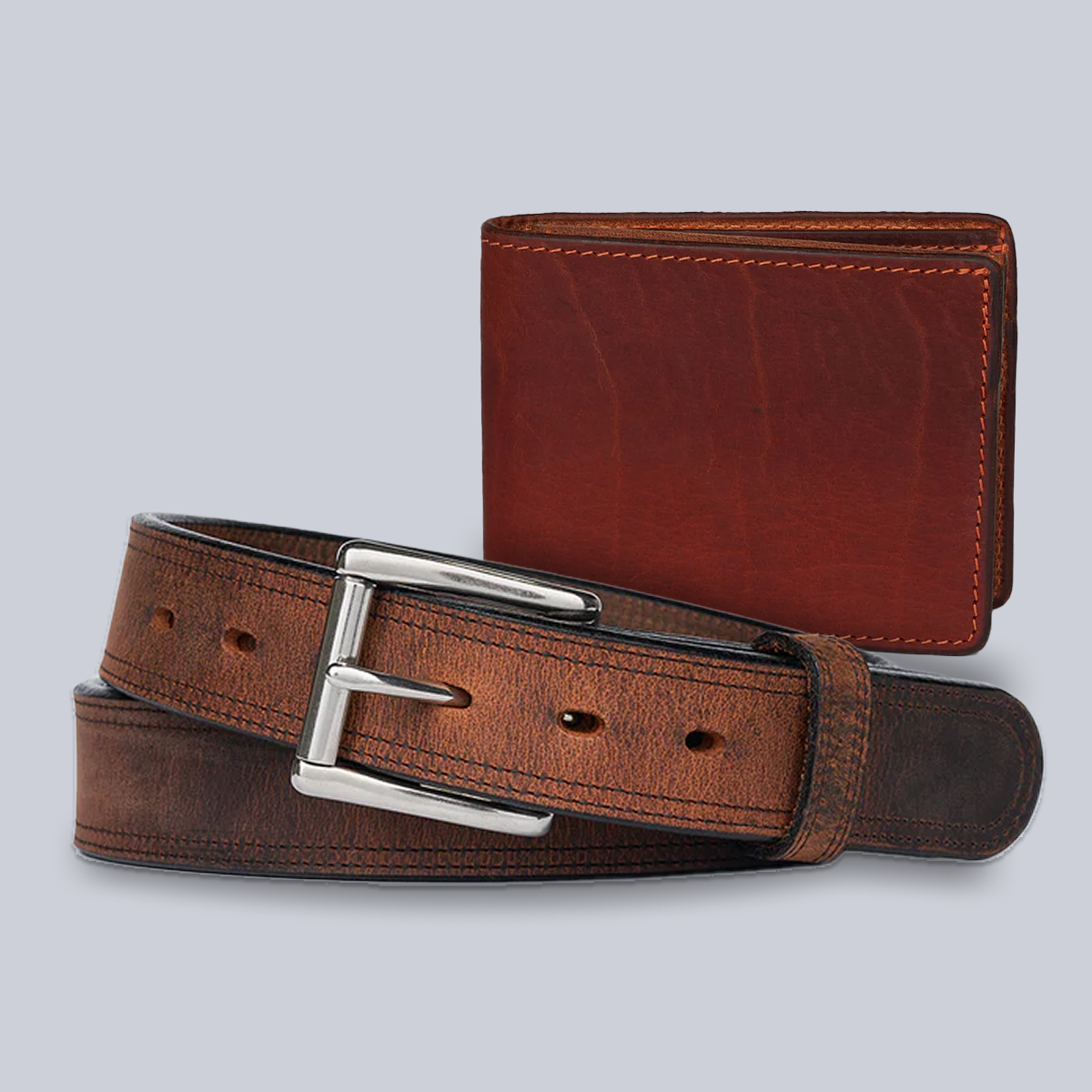 The Bundle: Montana Belt + Powell Wallet from Hanks Belts, both in brown bison leather, are displayed coiled and folded on a light gray background.