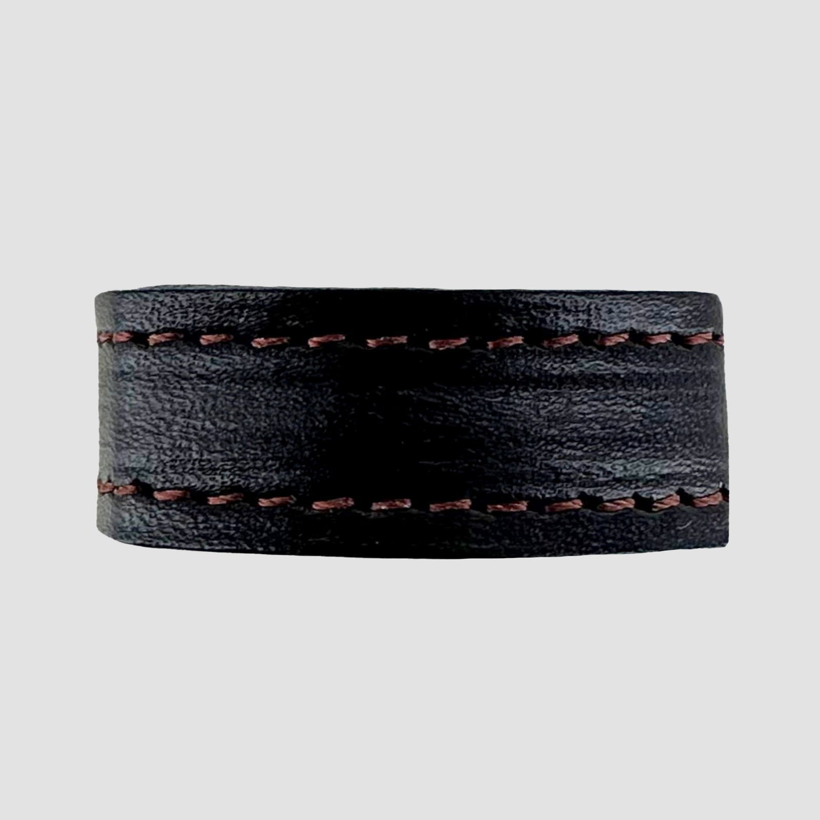 The 1.25" Stitched #10 Keeper by Hanks Belts is a wide black leather ring with brown stitching on the top and bottom edges, displayed on a plain light gray background.