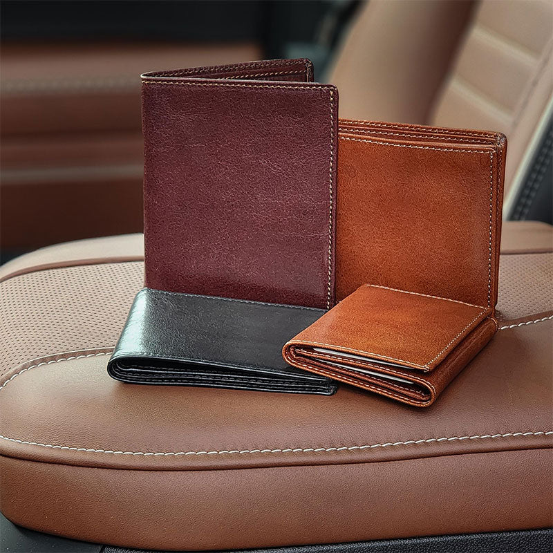 4 Italian wallets sitting on leather console