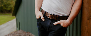 Male model leaning against a green barn wearing Hanks Wyoming 1.5