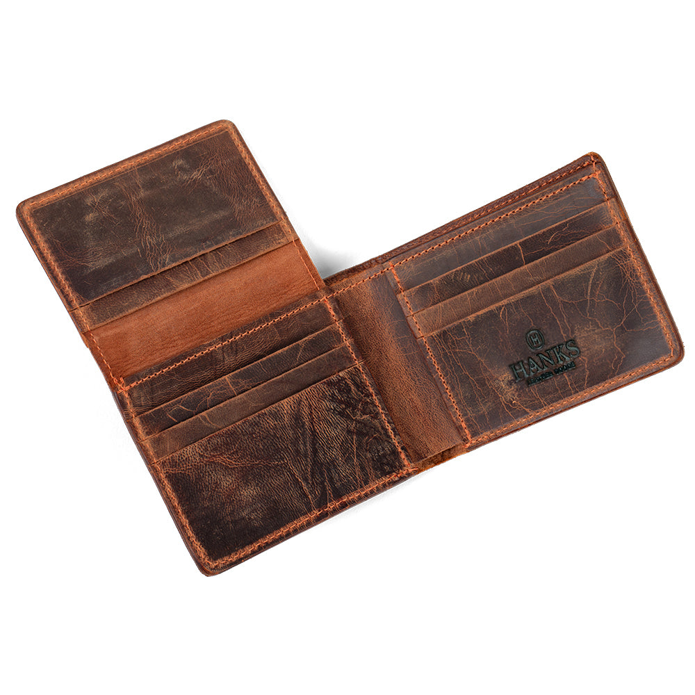 The Powell Bison Bifold with ID Window by Hanks Belts is an open leather wallet featuring multiple card slots, compartments, visible &quot;Hanks&quot; branding on the right side, and slight wear—making it a practical gift choice.