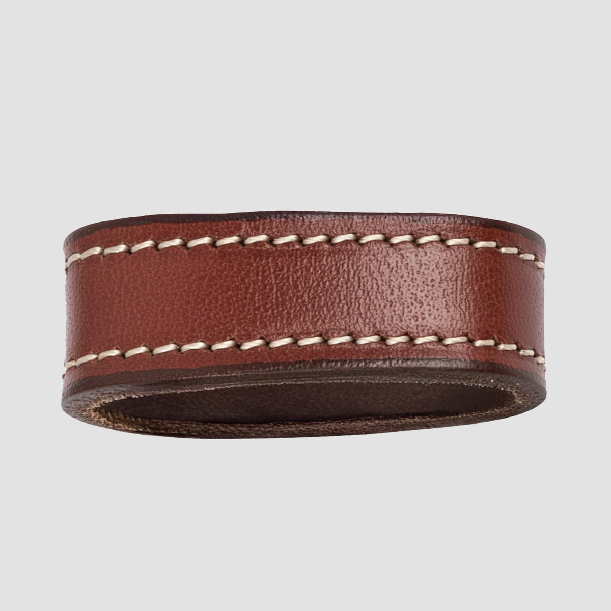 The Hanks Belts 1.25" Stitched #10 Keeper is a brown leather napkin ring with white edge stitching, resembling a dress belt keeper, shown on a plain light gray background.