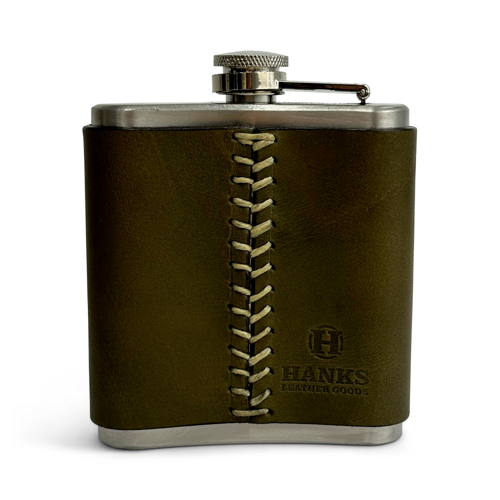 A Leather Covered Flask by Hanks Belts, featuring brown USA-tanned leather with decorative stitching down the middle and embossed with the brand name. It has metal accents, including a screw-on cap.