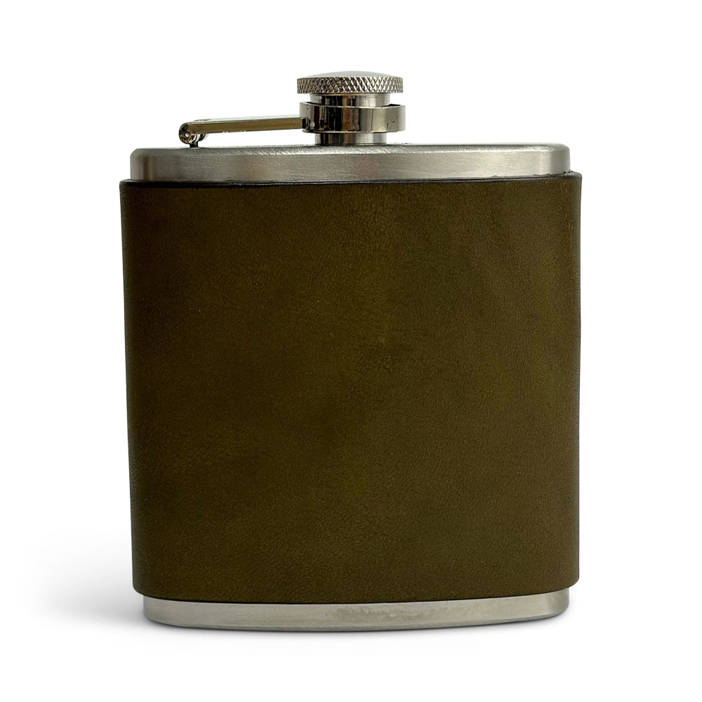 An olive Leather Covered Flask from Hanks Belts, made with USA tanned leather and stainless steel, featuring a screw-top lid with a security arm to prevent loss. The leather-wrapped flask is shown standing upright against a plain white background.