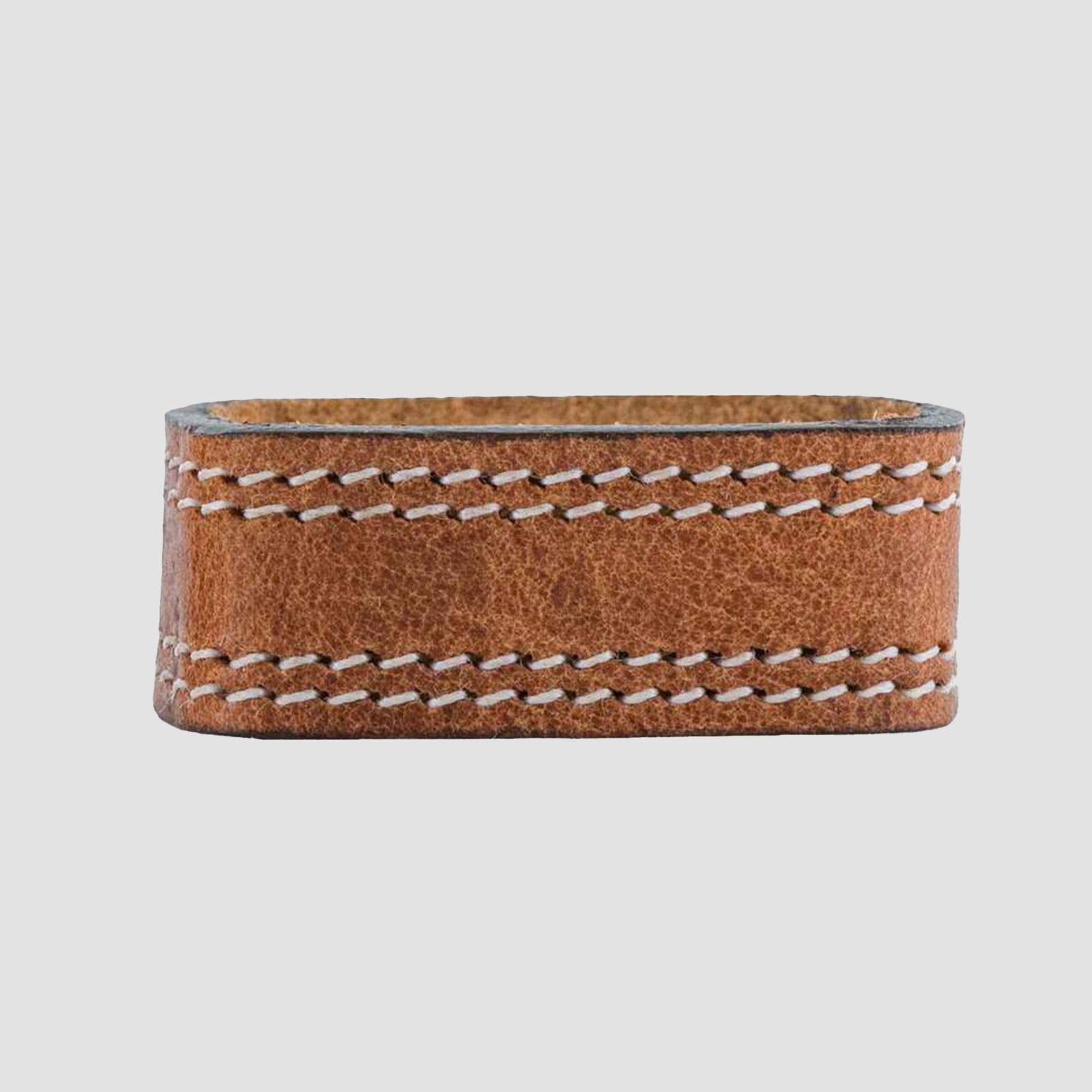 The Hanks Belts 1.5" Double Stitched #4 Keeper, made of harness leather with visible white stitching, recalls the craftsmanship of Old World Harness Belts and is shown against a plain light gray background.